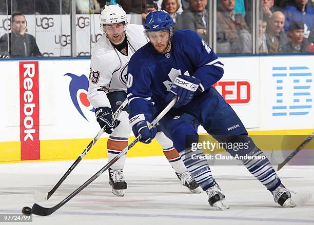 Christian Hanson of the Toronto Maple Leafs gets a pass in front of Sam Gagner of the Edmonton Oilers in a game on March 13, 2010 at the Air Canada...