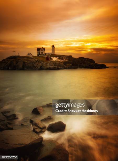 seascape with nubble lighthouse at sunset, maine, usa - shavkat stock-fotos und bilder