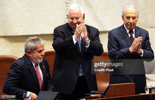 Brazilian President Luiz Inacio Lula da Silva is applauded by Israeli President Shimon Peres and Knesset speaker Reuvin Rivlin after finishing his...