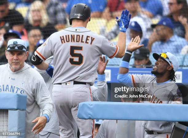 Nick Hundley of the San Francisco Giants is welcomed into the dugout after a 2 run home run against the Los Angeles Dodgers in the first inning at...