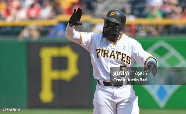 Josh Harrison of the Pittsburgh Pirates reacts after hitting an RBI single in the seventh inning during the game against the Cincinnati Reds at PNC...