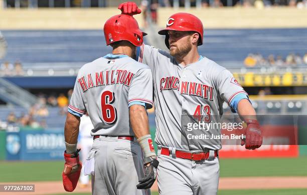 Scott Schebler of the Cincinnati Reds celebrates with Billy Hamilton after hitting a two run home run in the ninth inning during the game against the...