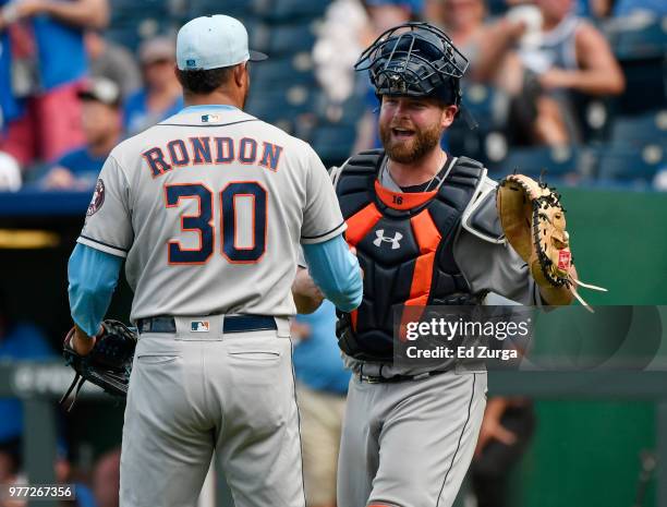 Hector Rondon and Brian McCann of the Houston Astros celebrate a 7-4 win against the Kansas City Royals at Kauffman Stadium on June 17, 2018 in...