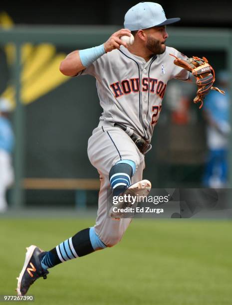 Jose Altuve of the Houston Astros throws to first base to complete a double play to end a game against the Kansas City Royals at Kauffman Stadium on...