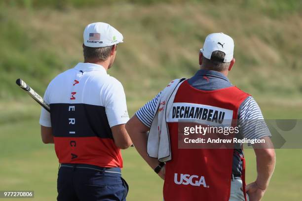 Bryson DeChambeau of the United States and caddie Tim Tucker walk off the 18th green during the final round of the 2018 U.S. Open at Shinnecock Hills...