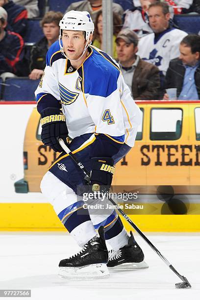 Defenseman Eric Brewer of the St. Louis Blues skates with the puck against the Columbus Blue Jackets on March 13, 2010 at Nationwide Arena in...