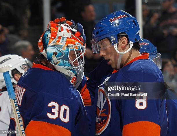 Goalie Dwayne Roloson and Bruno Gervais of the New York Islanders celebrate their 4-2 win over the New Jersey Devils after an NHL game at the Nassau...