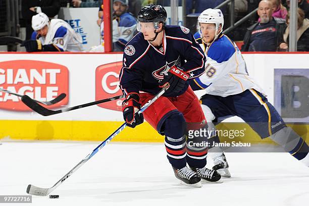 Defenseman Anton Stralman of the Columbus Blue Jackets skates with the puck against forward Jay McClement of the St. Louis Blues on March 13, 2010 at...