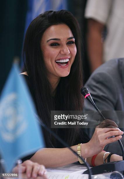 Bollywood actor Preity Zinta laughs at a press conference to announce her joining UNAIDS as a goodwill ambassador in New Delhi on March 11, 2010.