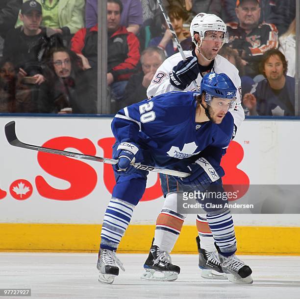 Christian Hanson of the Toronto Maple Leafs is held in check by Sam Gagner of the Edmonton Oilers in a game on March 13, 2010 at the Air Canada...