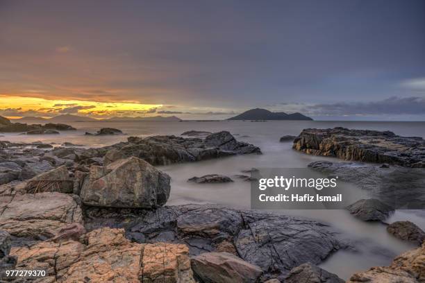 rocky sunset at turtle beach, singkawang (ii) - singkawang stock pictures, royalty-free photos & images