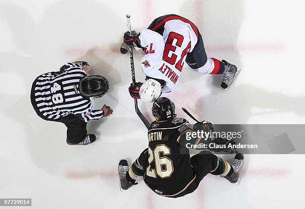 Michael Whaley of the Windsor Spitfires takes a faceoff against Colin Martin of the London Knights in a game on March 12, 2010 at the John Labatt...