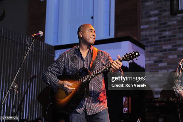 Former New York Yankee player Bernie Williams plays guitar on stage in front of 1,400 fans and fellow Cactus League players during Jake Peavy's...