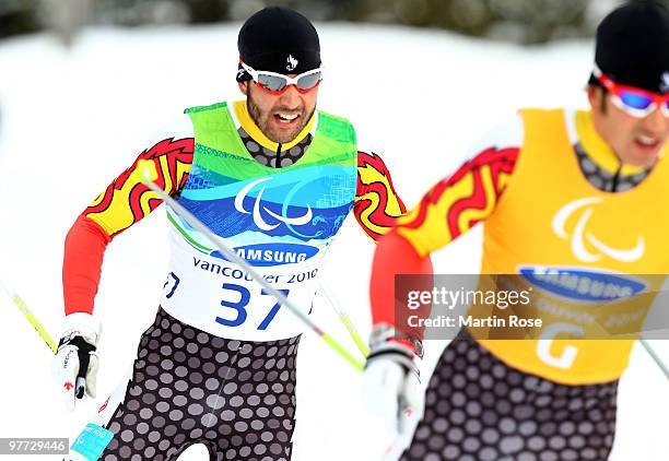 Gold medal winner Brian McKeever of Canada is led by his guide Robin McKeever as he competes in the men's visually impaired 20km free cross-country...