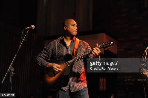 Former New York Yankee player Bernie Williams plays guitar on stage in front of 1,400 fans and fellow Cactus League players during Jake Peavy's...