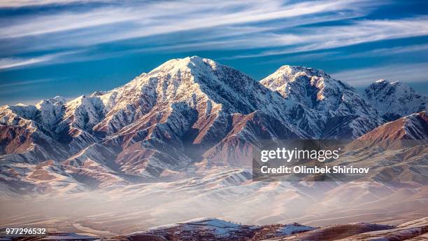 mountains covered in snow, tajikistan - tadjik photos et images de collection