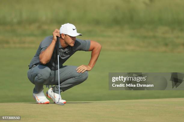 Brooks Koepka of the United States lines up a putt on the 13th green during the final round of the 2018 U.S. Open at Shinnecock Hills Golf Club on...