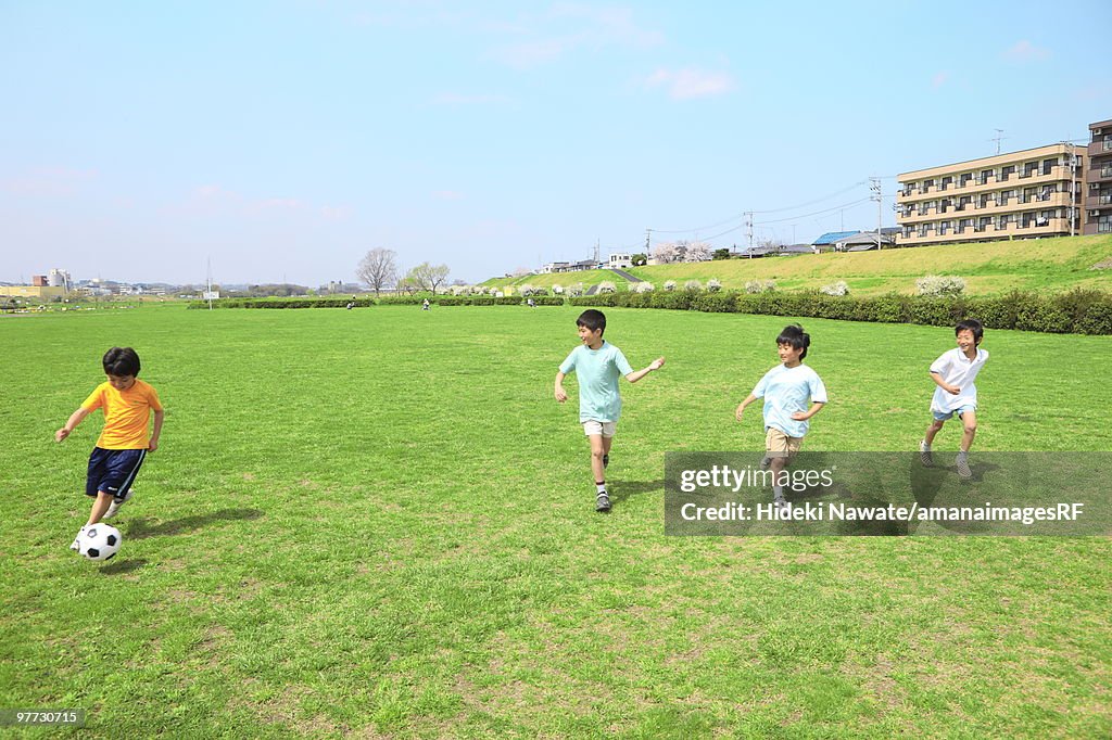 Young boys playing soccer on field. Futako-tamagawa, Setagaya-ku, Tokyo Prefecture, Japan