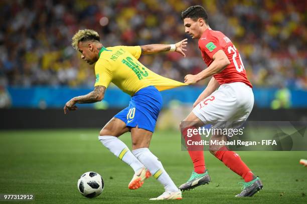 Fabian Schaer of Switzerland pulls Neymar Jr of Brazil back the 2018 FIFA World Cup Russia group E match between Brazil and Switzerland at Rostov...