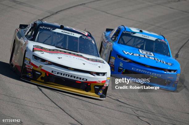 Michael Annett, driver of the Northland Oil Chevrolet, races Matt Tifft, driver of the Wastebits Chevrolet, during the NASCAR Xfinity Series Iowa 250...