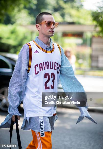 Guest wearing basketball jersey is seen outside MSGM during Milan Men's Fashion Week Spring/Summer 2019 on June 17, 2018 in Milan, Italy.