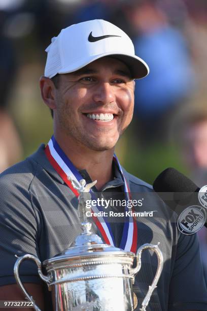 Brooks Koepka of the United States is interviewed during the trophy presentation after winning the 2018 U.S. Open at Shinnecock Hills Golf Club on...