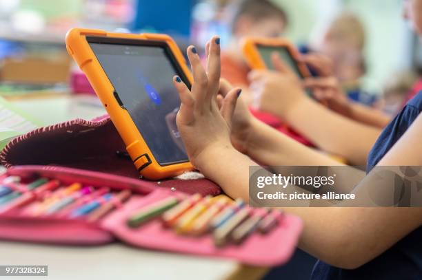 April 2018, Germany, Abensberg: Schoolchildren use tablets in class at the Primary School Offenstetten. The school participares in the project...