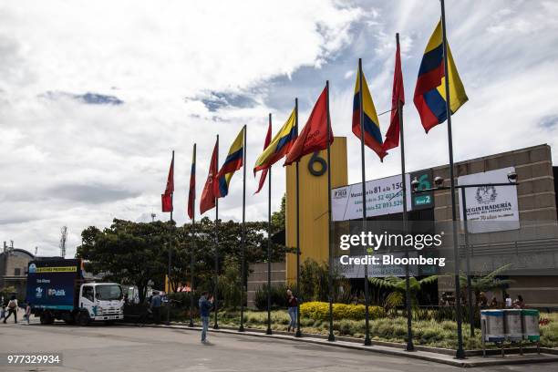 Voters take photographs underneath Colombia flags outside the Corferias polling station during the second round of presidential elections in Bogota,...