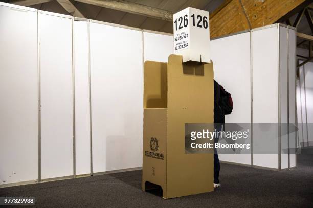 Voter marks a ballot at a booth inside the Corferias polling station during the second round of presidential elections in Bogota, Colombia, on...