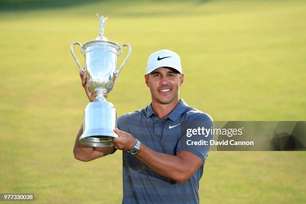 Brooks Koepka of the United States holds the trophy after his one shot victory during the final round of the 2018 US Open at Shinnecock Hills Golf...