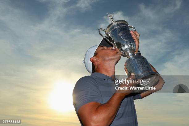 Brooks Koepka of the United States kisses the U.S. Open Championship trophy after winning the 2018 U.S. Open at Shinnecock Hills Golf Club on June...