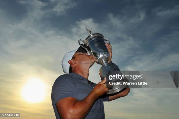 Brooks Koepka of the United States kisses the U.S. Open Championship trophy after winning the 2018 U.S. Open at Shinnecock Hills Golf Club on June...