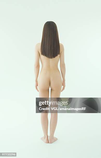 naked woman standing with back to camera - asian pin up girls stock-fotos und bilder