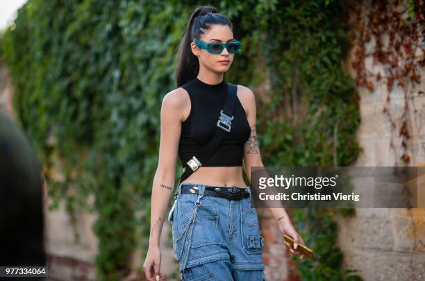 Guest wearing cropped top is seen outside Palm Angels during Milan Men's Fashion Week Spring/Summer 2019 on June 17, 2018 in Milan, Italy.