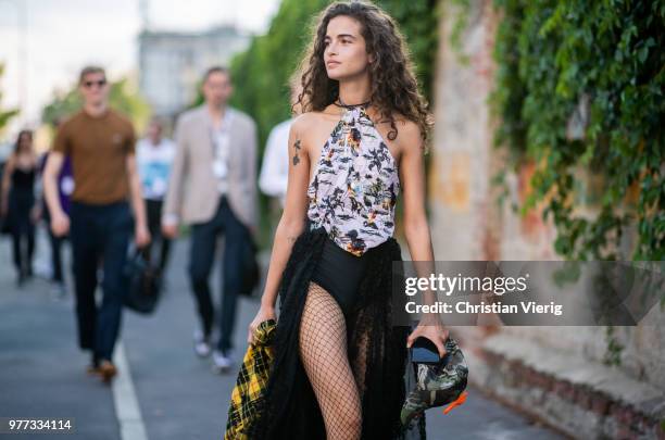 Model Chiara Scelsi wearing net tights, body, plattform shoes is seen outside Palm Angels during Milan Men's Fashion Week Spring/Summer 2019 on June...