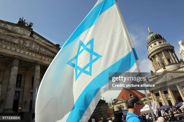 May 2018, Germany, Berlin: People taking part in the celebration of the independence of Israel at the Gendarmenmarkt with an Israeli flag. Photo:...