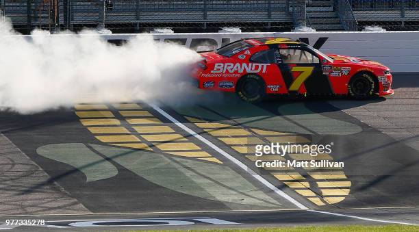 Justin Allgaier, driver of the BRANDT Professional Agriculture Chevrolet, celebrates by doing a burn out after winning the NASCAR Xfinity Series Iowa...
