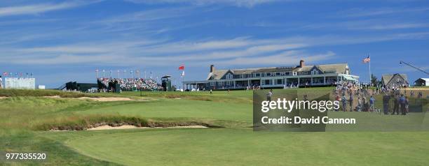 Tommy Fleetwood of England plays his second shot on the 18th hole on his way to scoring a seven under par 63 and ultimate second place by one shot to...