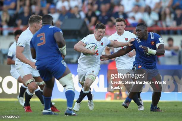 Ben Curry of England hands off Jordan Joseph of France during the World Rugby via Getty Images Under 20 Championship Final between England and France...