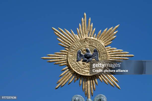 May 2018, Germany, Berlin: The old emblem of Prussia can be seen outside Charlottenburg Palace. Photo: Ralf Hirschberger/dpa