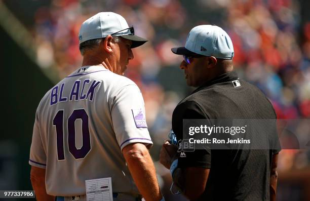Manager Bud Black of the Colorado Rockies talks with umpire Alan Porter against the Texas Rangers during the seventh inning at Globe Life Park in...