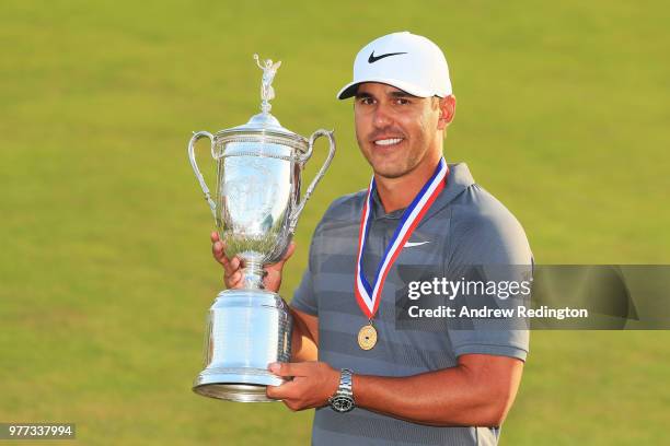 Brooks Koepka of the United States celebrates with the U.S. Open Championship trophy after winning the 2018 U.S. Open at Shinnecock Hills Golf Club...
