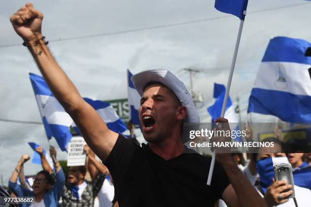 An anti-government demonstrator takes part in a protest in Managua, Nicaragua on June 17 demanding justice for the death of six members of a single...