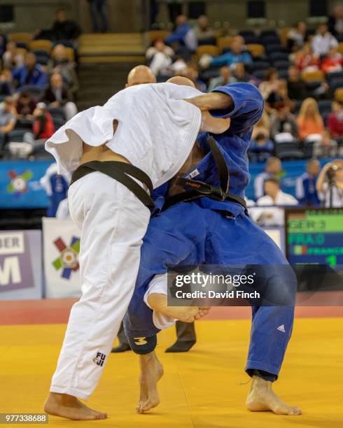 Marcus Utzat of Germany throws Franck Chazeirat of France for an ippon to help Germany to a 5/0 defeat of France in their M4 quarter-final match...