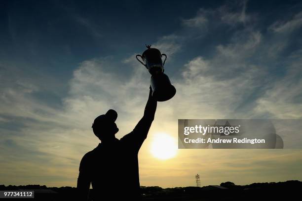 Brooks Koepka of the United States celebrates with the U.S. Open Championship trophy after winning the 2018 U.S. Open at Shinnecock Hills Golf Club...