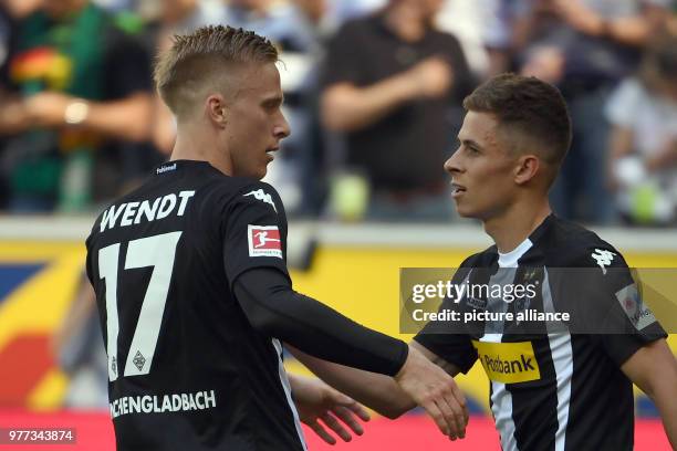 Moenchengladbach's Thorgan Hazar celebreates, with teammates Oscar Wendt, scoring his side's 1st goal during the German Bundesliga soccer match...