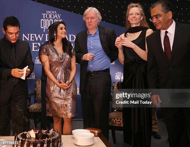 Aamir Khan, Asin and James Cameroon with his wife Suzy Amis and Aroon Purie get ready to cut Aamir's birthday cake at the dinner party hosted after...