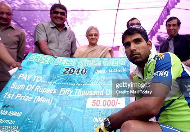 Sheila Dikshit gives away the prize to winner Atul Kumar the Green Delhi Cycle Rally 2010 in New Delhi on March 14, 2010.