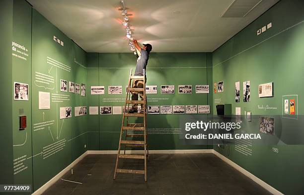 Worker fixes the lighting at the Bicentennial House in Buenos Aires on March 15 the day before its opening. A history of the Mothers of Plaza de Mayo...