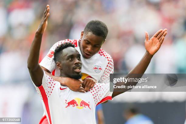 Leipzig's Jean-Kevin Augustin celebrates scoring his side's 4th goal, with teammate Ademola Lookman, during the German Bundesliga soccer match...